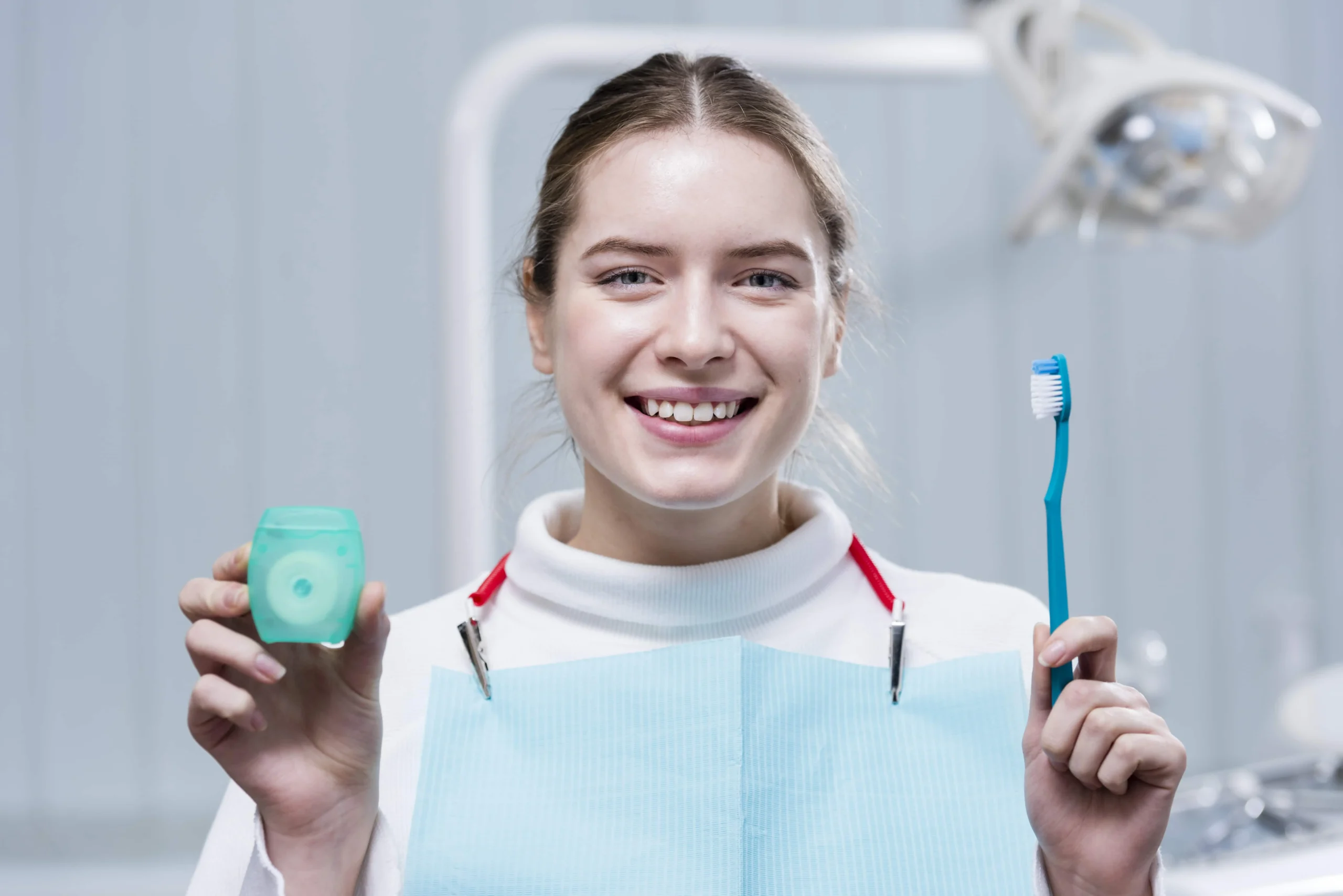 happy-young-woman-holding-toothbrush-min